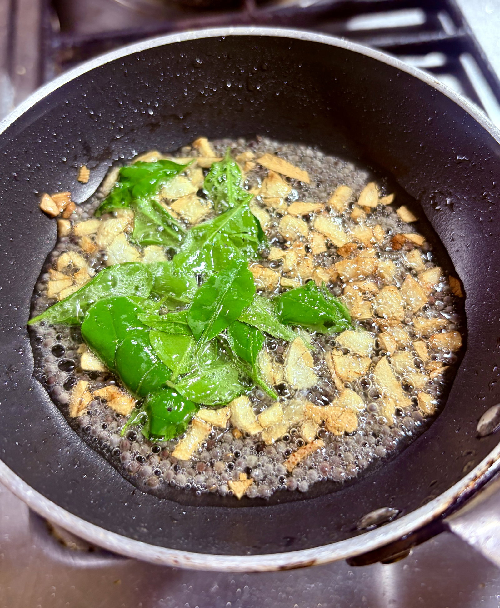 Step 3.1: Turn off the heat, toss in the curry leaves, and let them sizzle