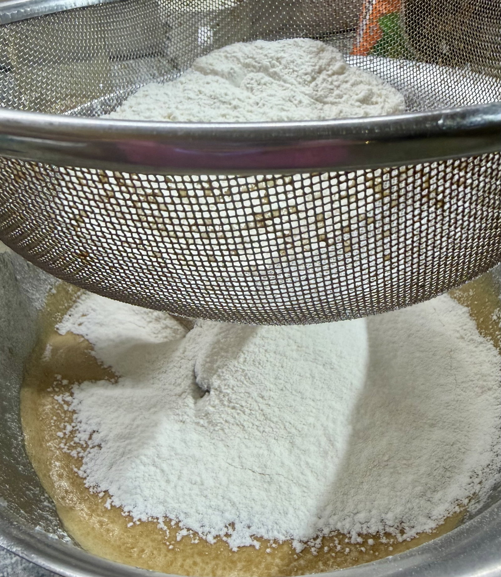 Step 3.1: Sift the all-purpose flour and baking powder directly into the wet mix