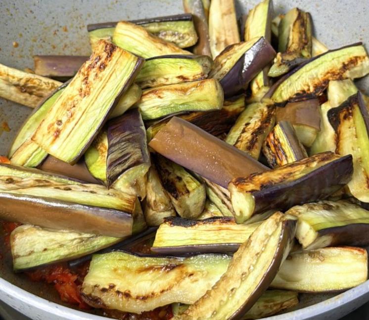 Step 1.1: Add the eggplant and cook for 2 more minutes until it's well coated in the spice paste and evenly seasoned