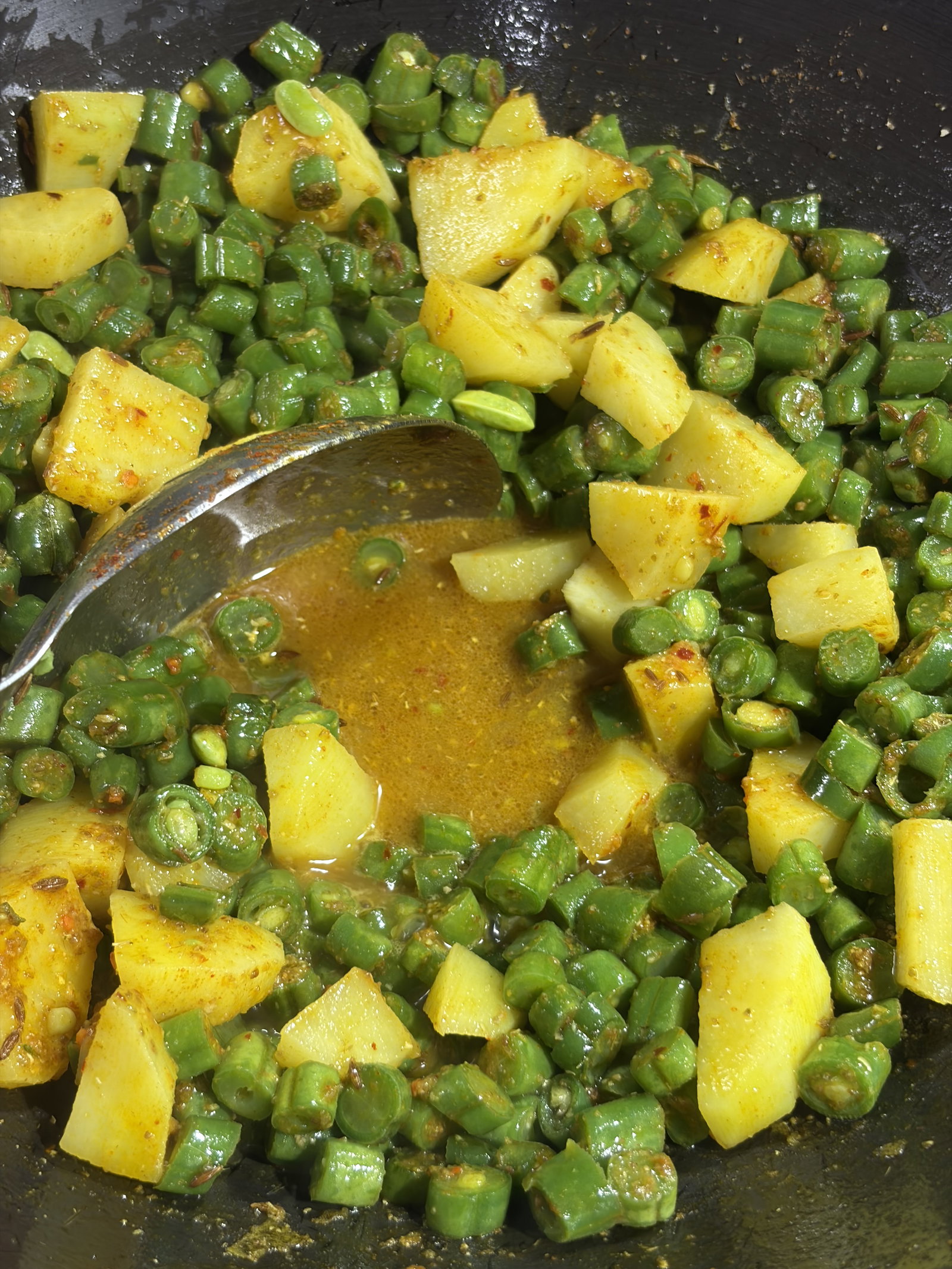 Step 4.1: Pour in ¼ cup of water, cover the pan, and cook on low to medium heat