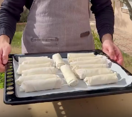 Step 3.2: Add filling, roll tightly, seal the edges, and brush the tops again with ghee or butter