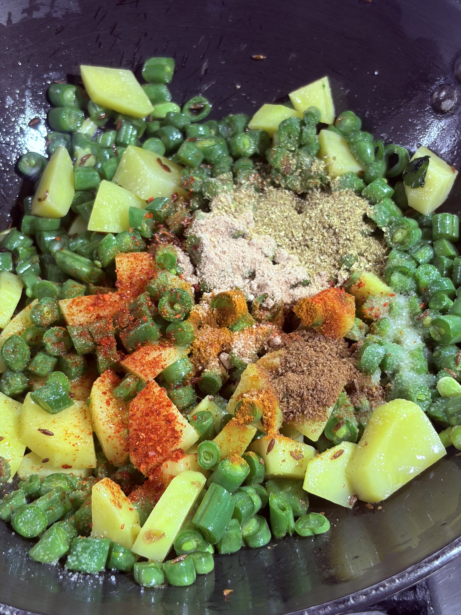Step 4.1: Lower the heat and add turmeric, coriander powder, cumin powder, red chilli, and amchur