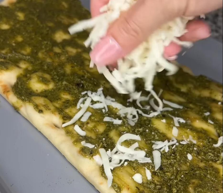 Step 2.1: Place flatbreads on a baking sheet and top with pesto, mozzarella, red onion, chicken, and tomatoes