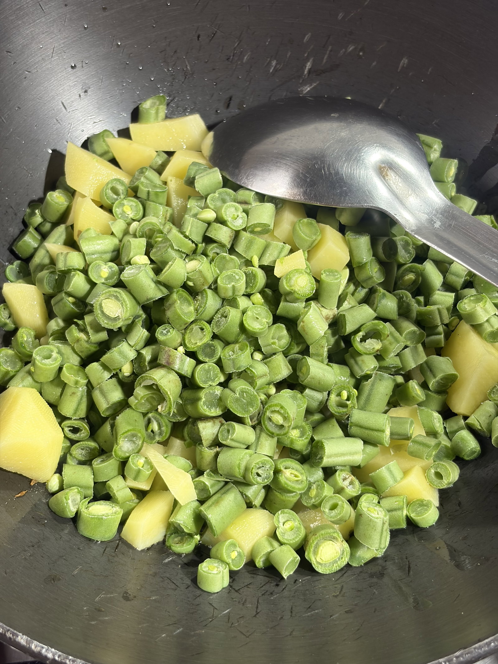 Step 3.1: Add the chopped beans and potatoes to the pan