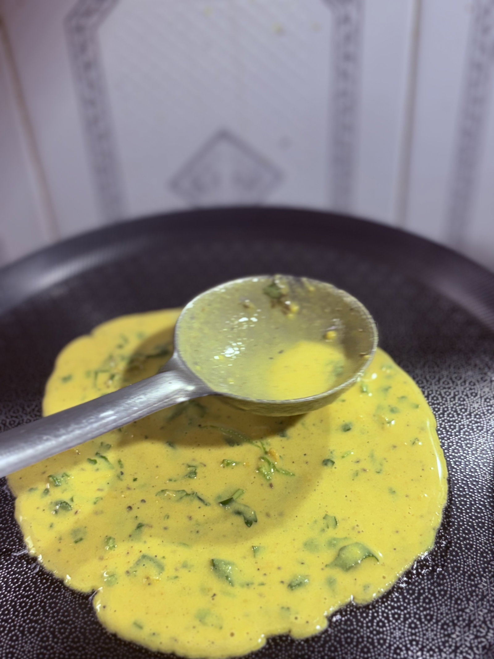 Step 1.2: Lower the heat and pour a ladleful of batter into the centre