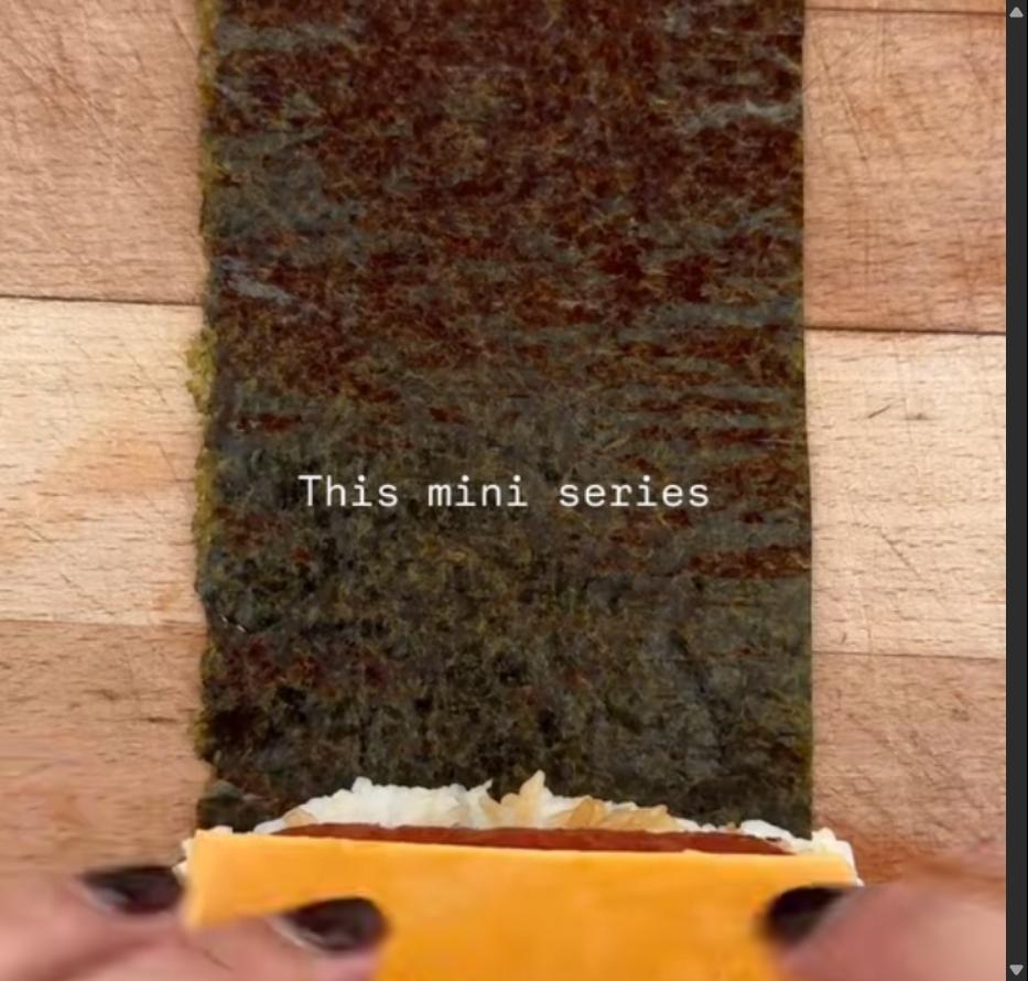 Step 1.1: Place seaweed on a chopping board, add rice, spam, and cheese, then fold into a parcel