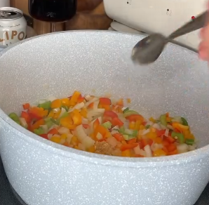 Step 2.1: Heat olive oil in a pan and cook onion, bell peppers, celery, jalapeños, and garlic until softened and fragrant
