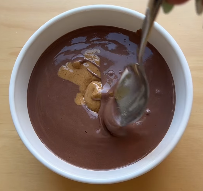 Step 1.1: Add a spoonful of peanut butter to the center and use a spoon to cover it with batter