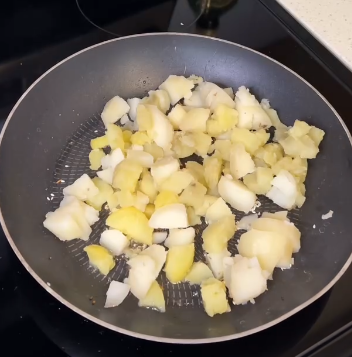 Step 1.1: Add the boiled potatoes to the skillet and mix well with the spices