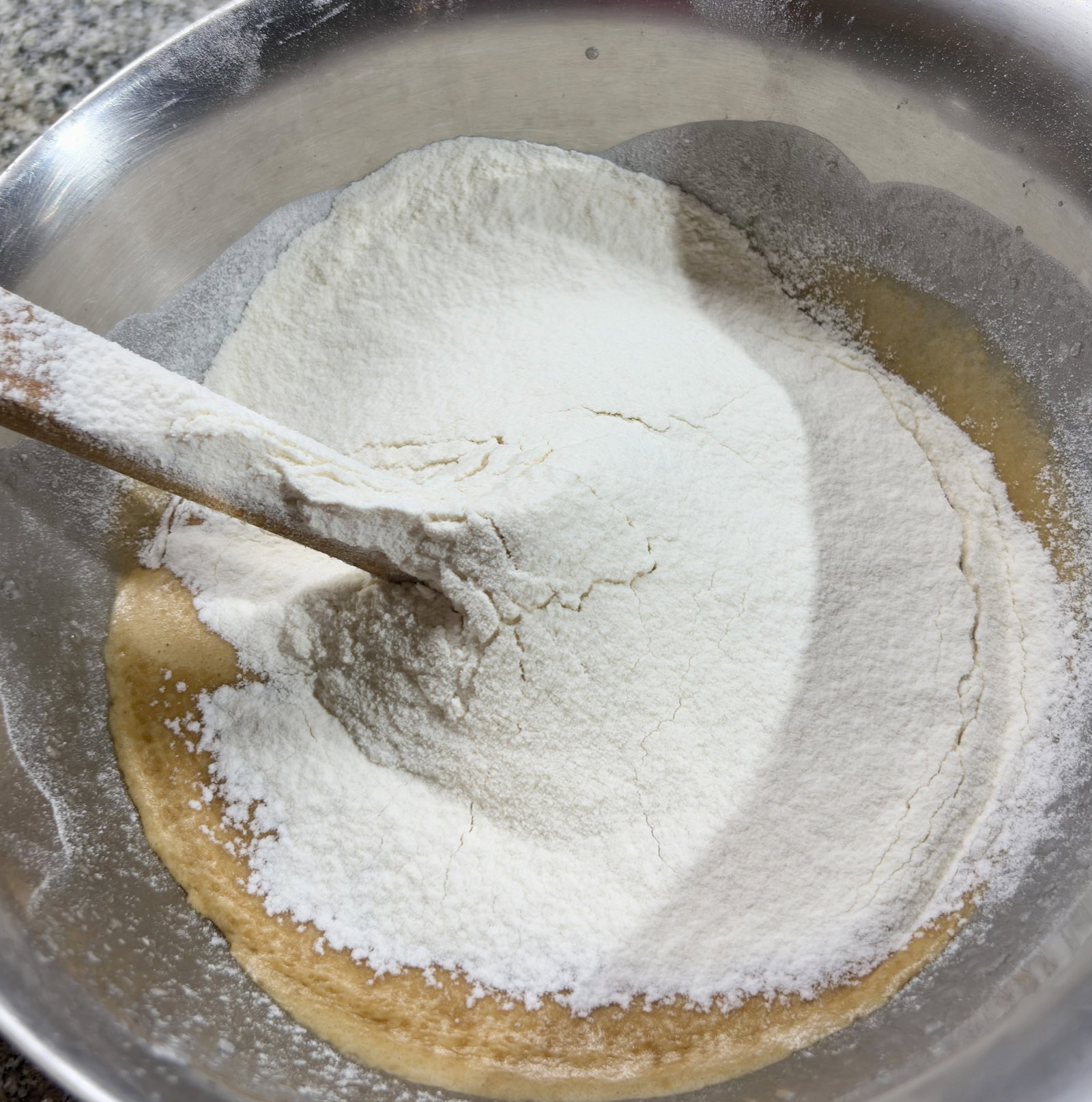 Step 3.2: Sift the all-purpose flour and baking powder directly into the wet mix