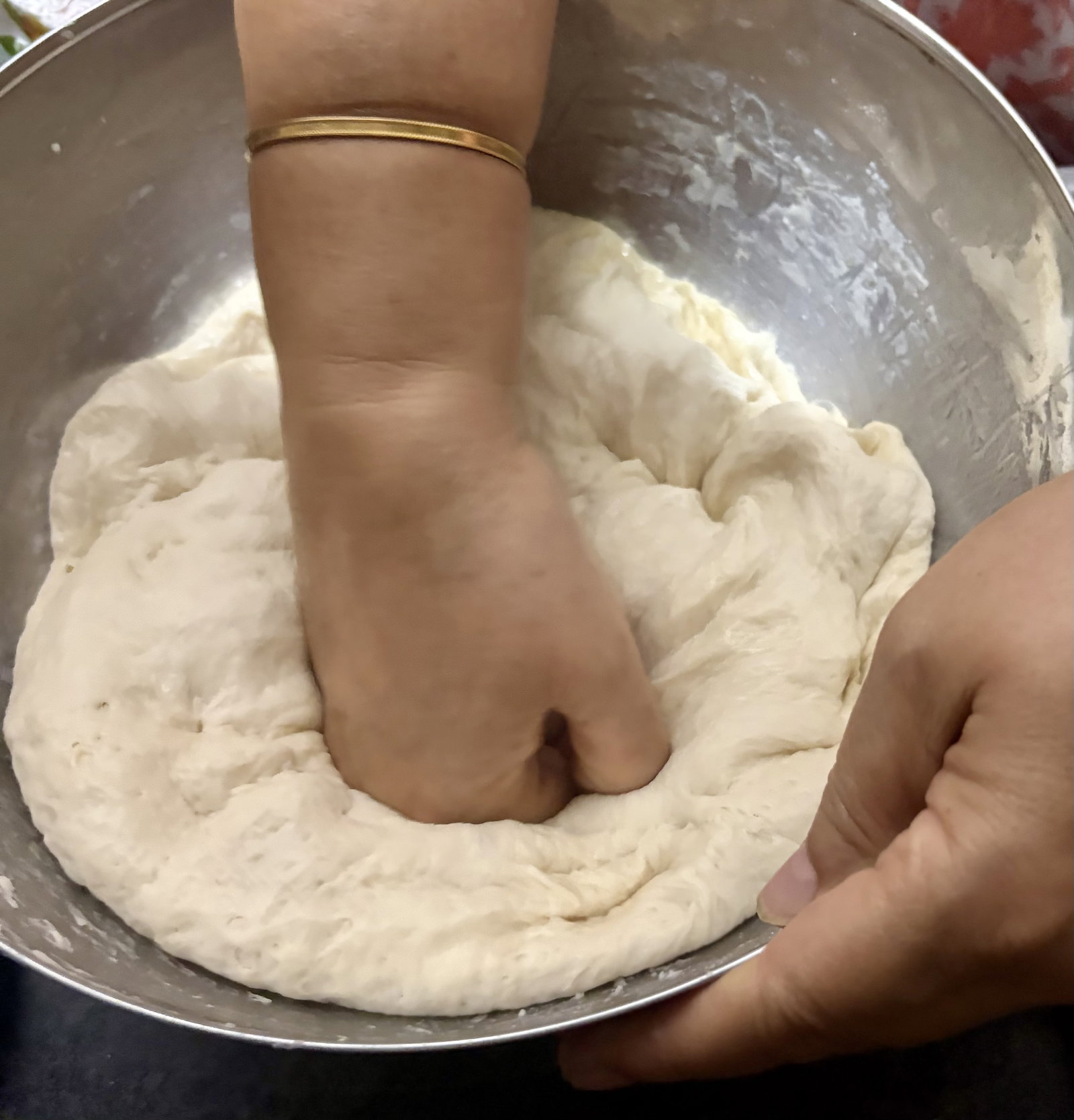 Step 4.1: Gently punch the risen dough to release the trapped air