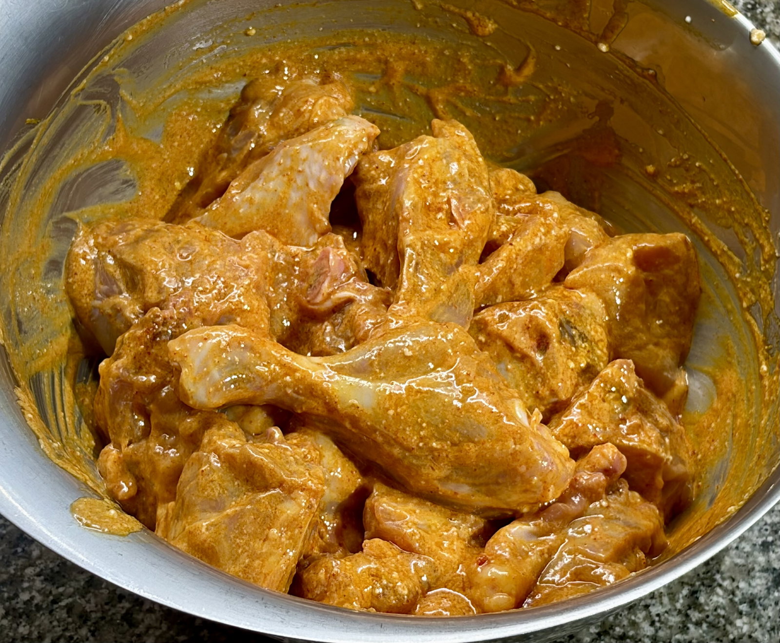 Step 1.1: In a large bowl, combine the chicken with salt, turmeric, Kashmiri chilli powder, yogurt, and mustard oil