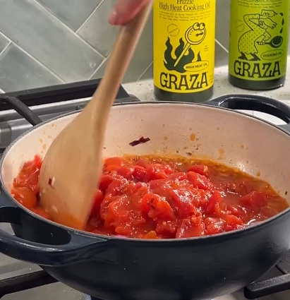 Step 1.1: Add canned tomatoes, salt, and pepper, and let simmer