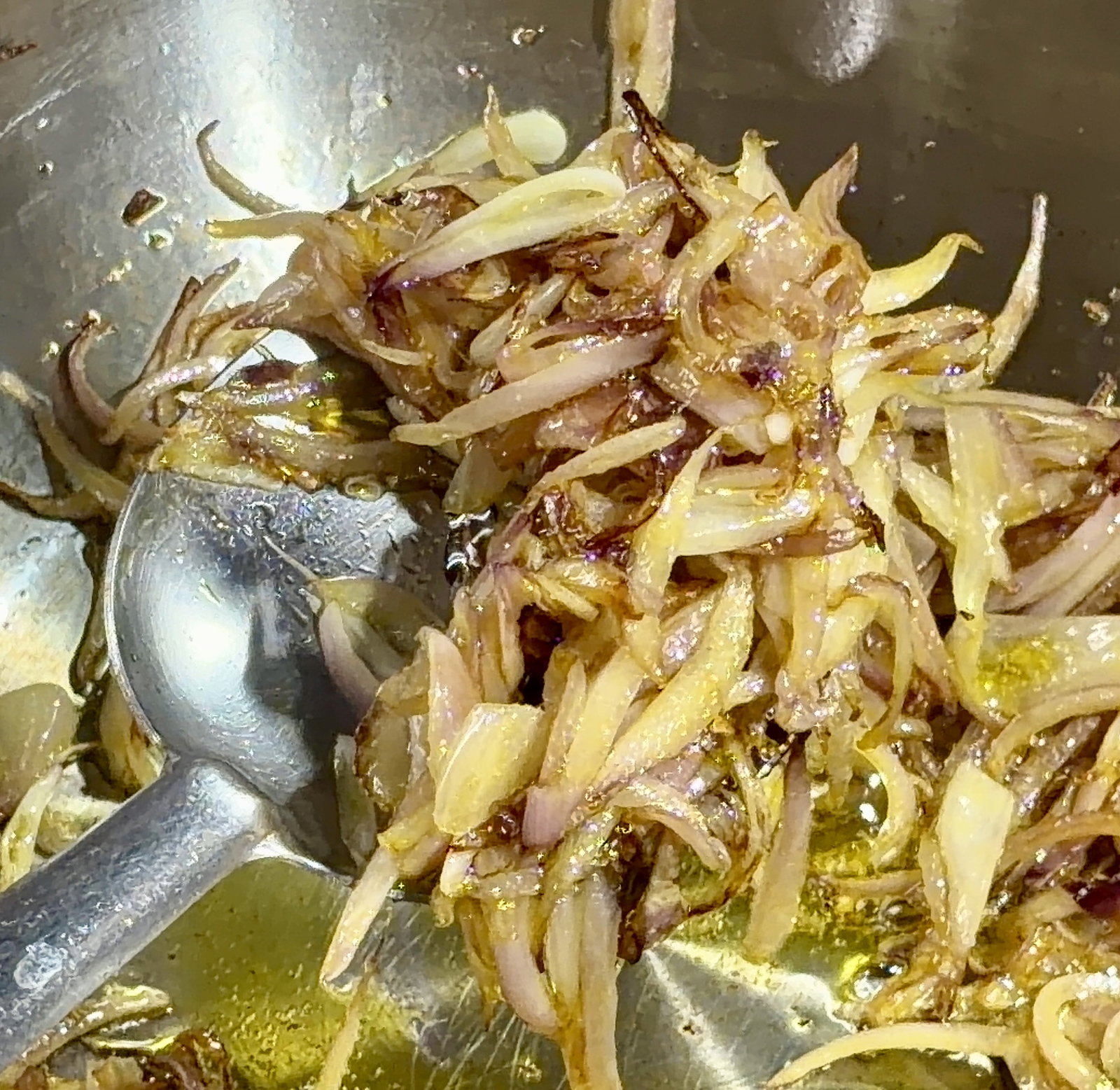 Step 3.1: Reduce the heat slightly, add the sliced onions, and sauté until they turn lightly golden and the edges begin to brown
