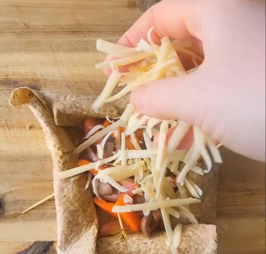 Step 1.1: Sprinkle grated cheddar over the filling