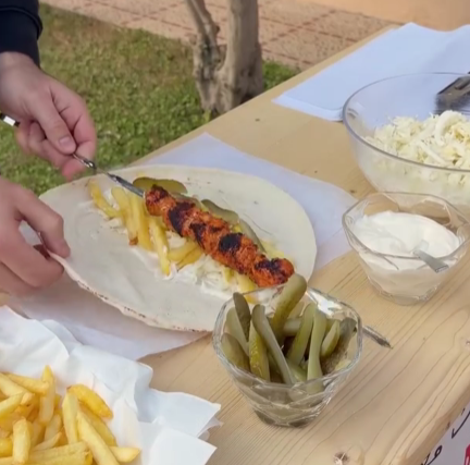 Step 3.1: Serve the grilled chicken in Lebanese bread with coleslaw, garlic paste, fries, and pickles