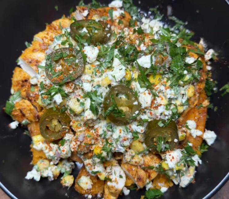 Step 4.1: Top sweet potatoes with Mexican street corn, chopped chipotle chicken, pickled jalapeños, and feta cheese
