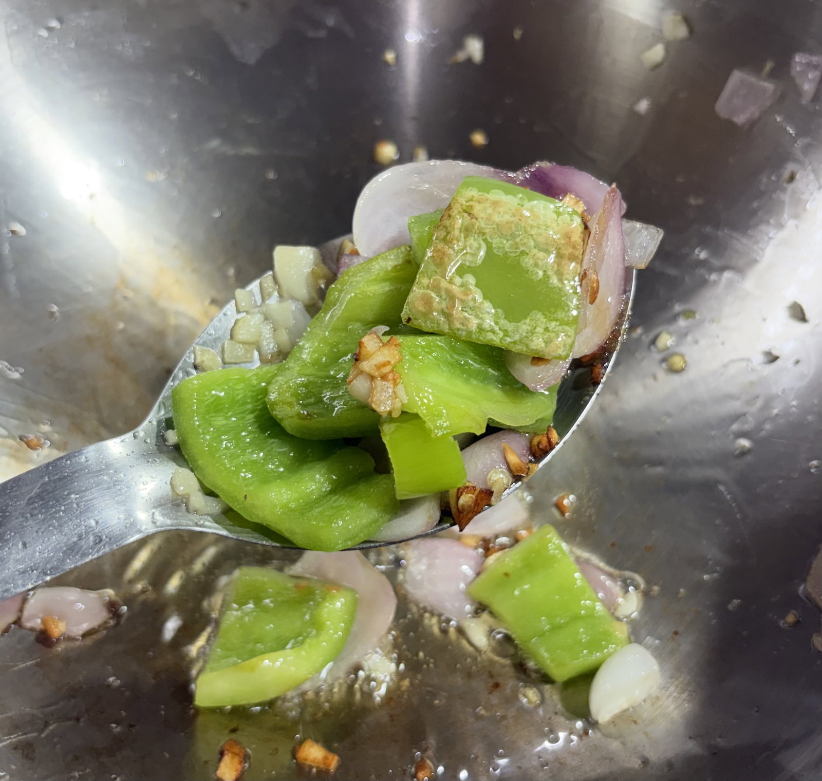 Step 2.2: Toss in cubed onion, capsicum, and sliced green chilli