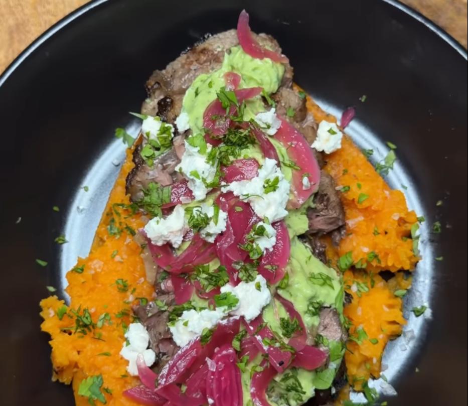 Step 4.1: Top sweet potatoes with avocado crema, sliced steak, pickled red onions, feta cheese, flakey salt, and fresh coriander
