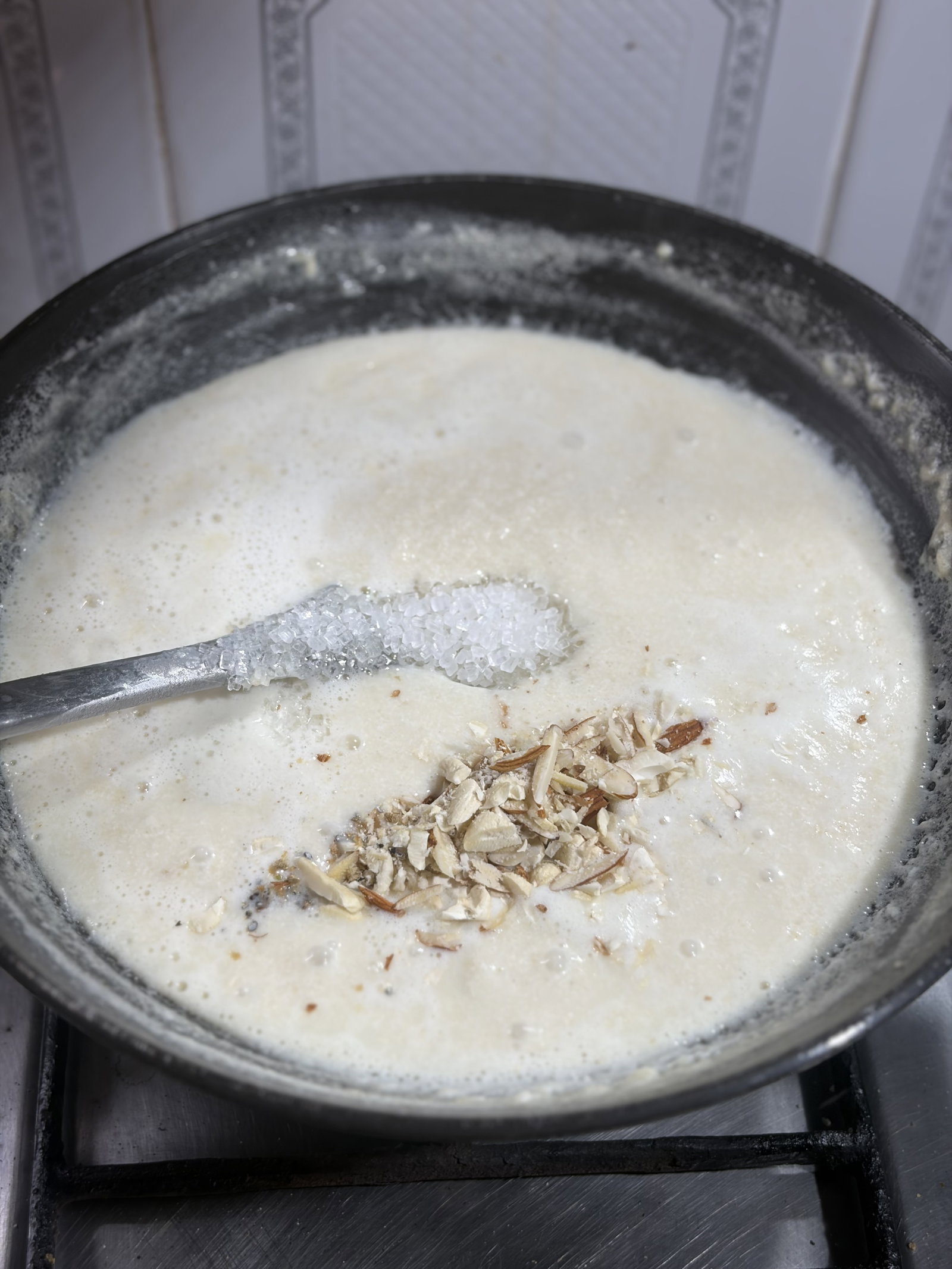Step 1.1: Add the sugar, chopped nuts, and cardamom powder