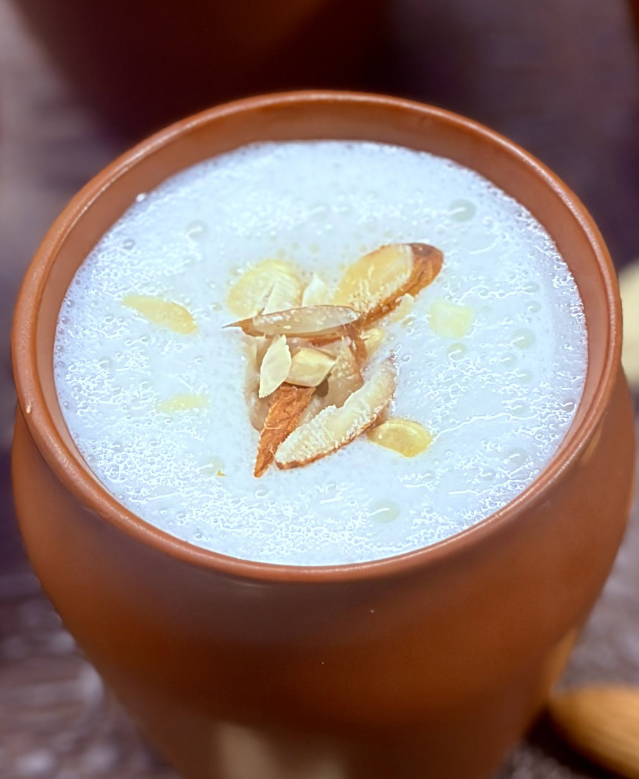 Step 3.1: Pour the chilled lassi into earthen cups or tall glasses and garnish with chopped nuts