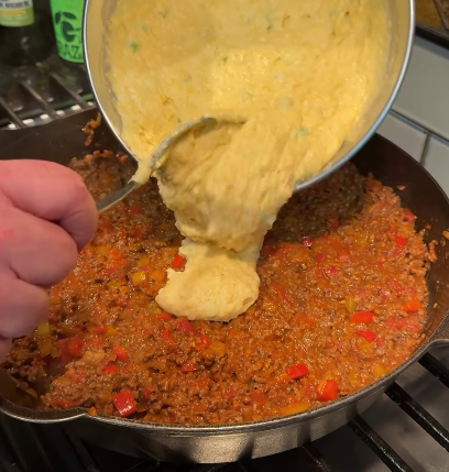 Step 3.1: Pour the cornbread batter evenly over the beef mixture