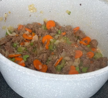 Step 1.1: Stir in onion, carrots, celery, garlic, Italian seasoning, red pepper flakes, salt, and pepper, and cook until veggies begin to soften