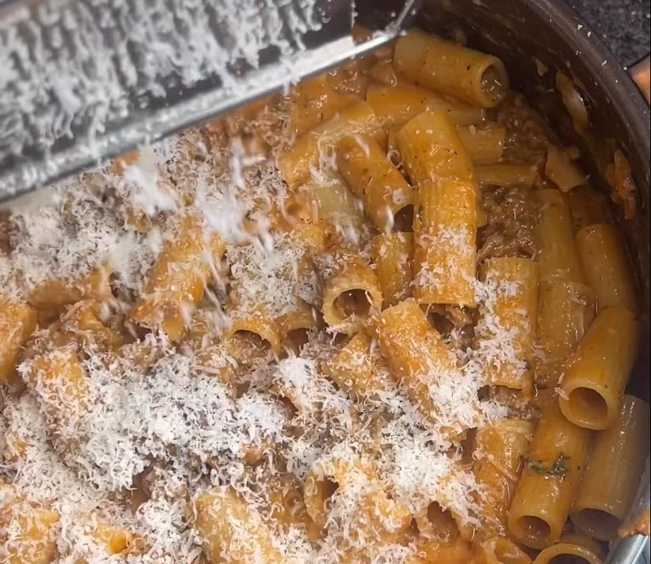 Step 1.1: Add pasta water for the desired consistency along with handfuls of Parmigiano Reggiano, stirring until melted and combined