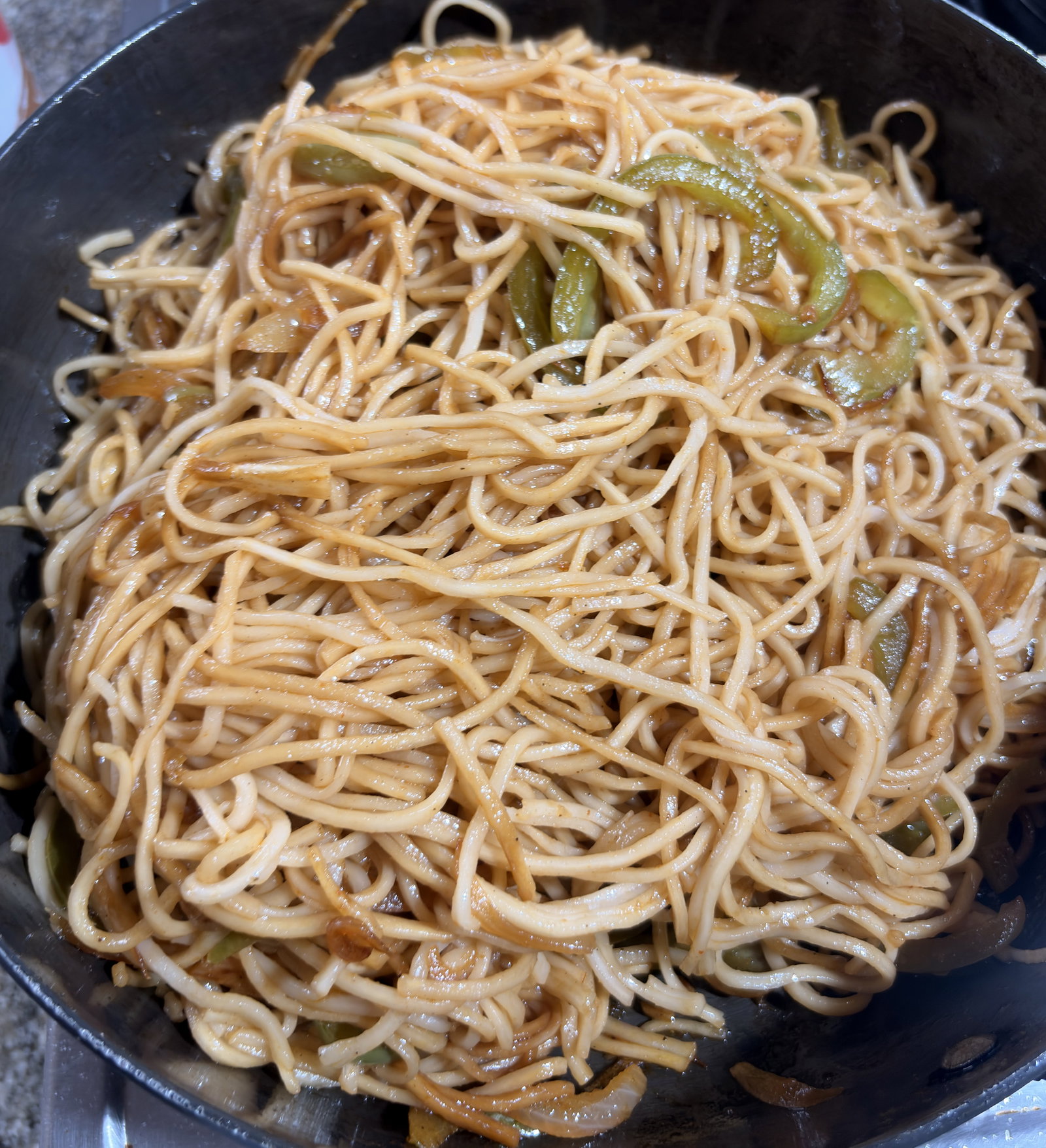Step 3.1: Add the cooked noodles to the pan and toss continuously until fully coated in the sauce