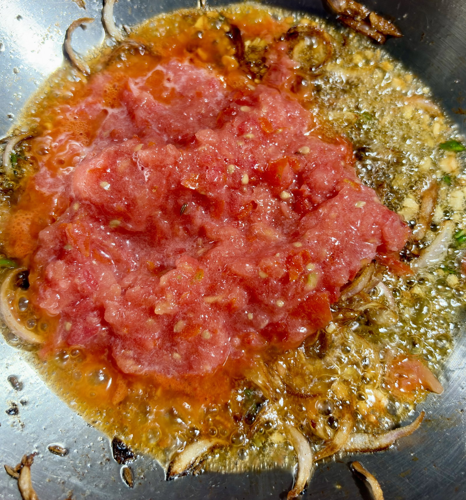 Step 2.1: Add the tomatoes and cook until they soften and the ghee begins to separate from the sides