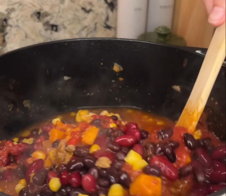 Step 1.1: Mix in crushed tomatoes, beans, chicken broth, and frozen corn