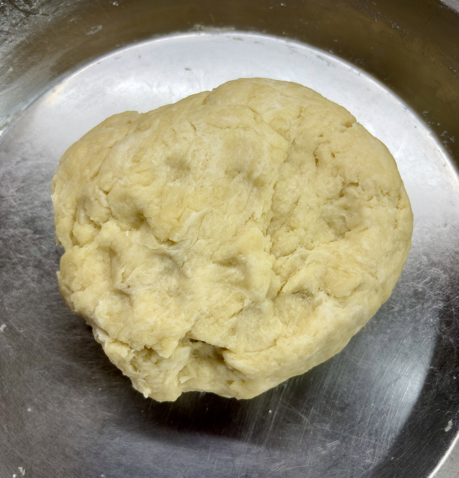 Step 2.1: Gradually add water to the flour mixture while mixing with light hands to form a dough