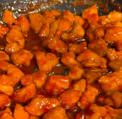 Step 1.1: Toss the crispy chicken in the warm orange glaze until well coated