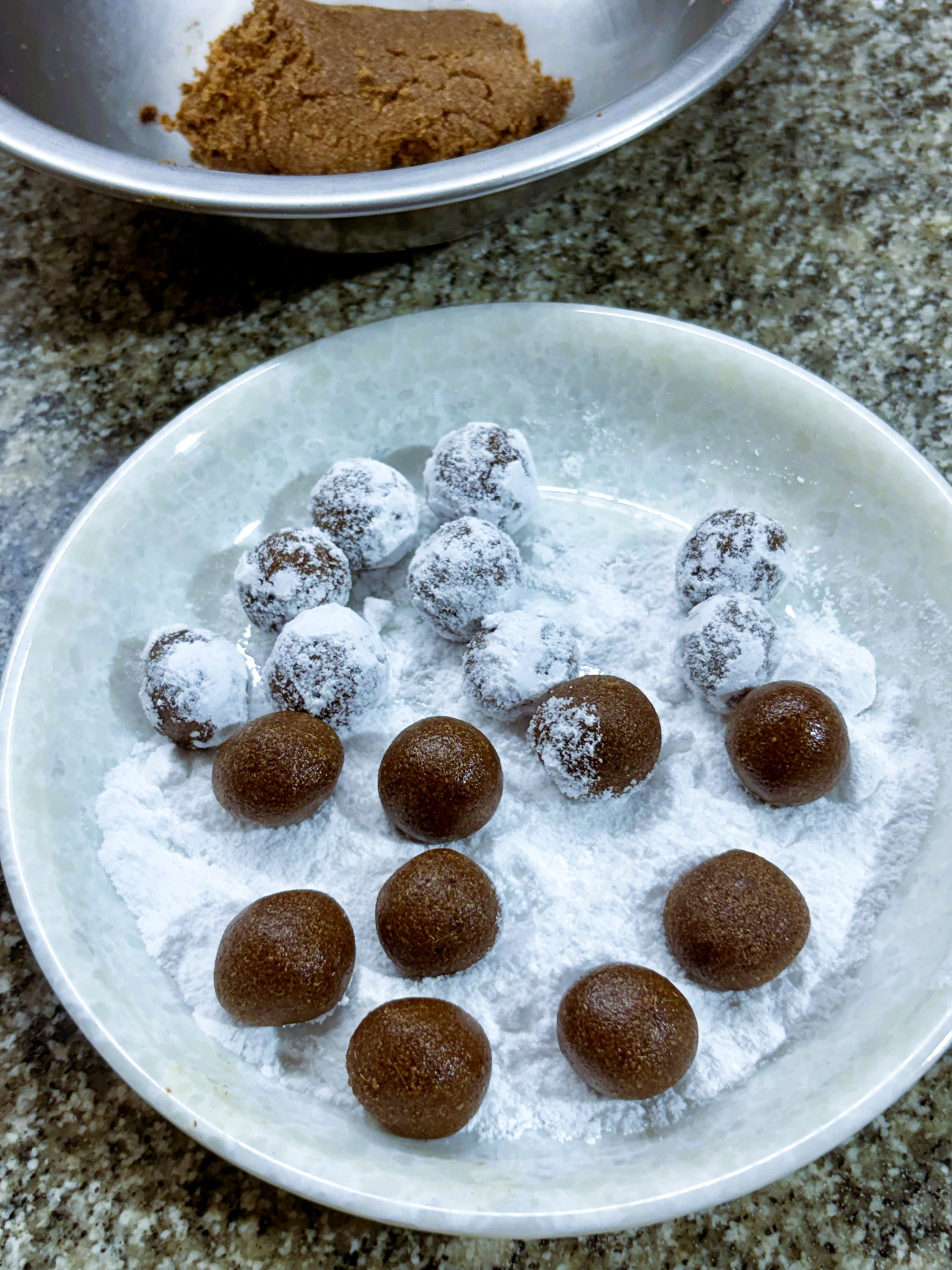 Step 4.2: Immediately roll each ball in extra powdered sugar until evenly coated, and place them on a clean, dry plate