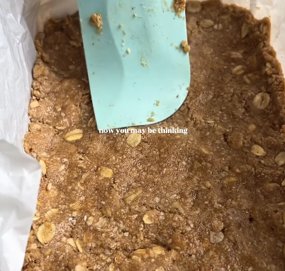Step 1.1: Press the mixture firmly into a lined baking tin to form an even base