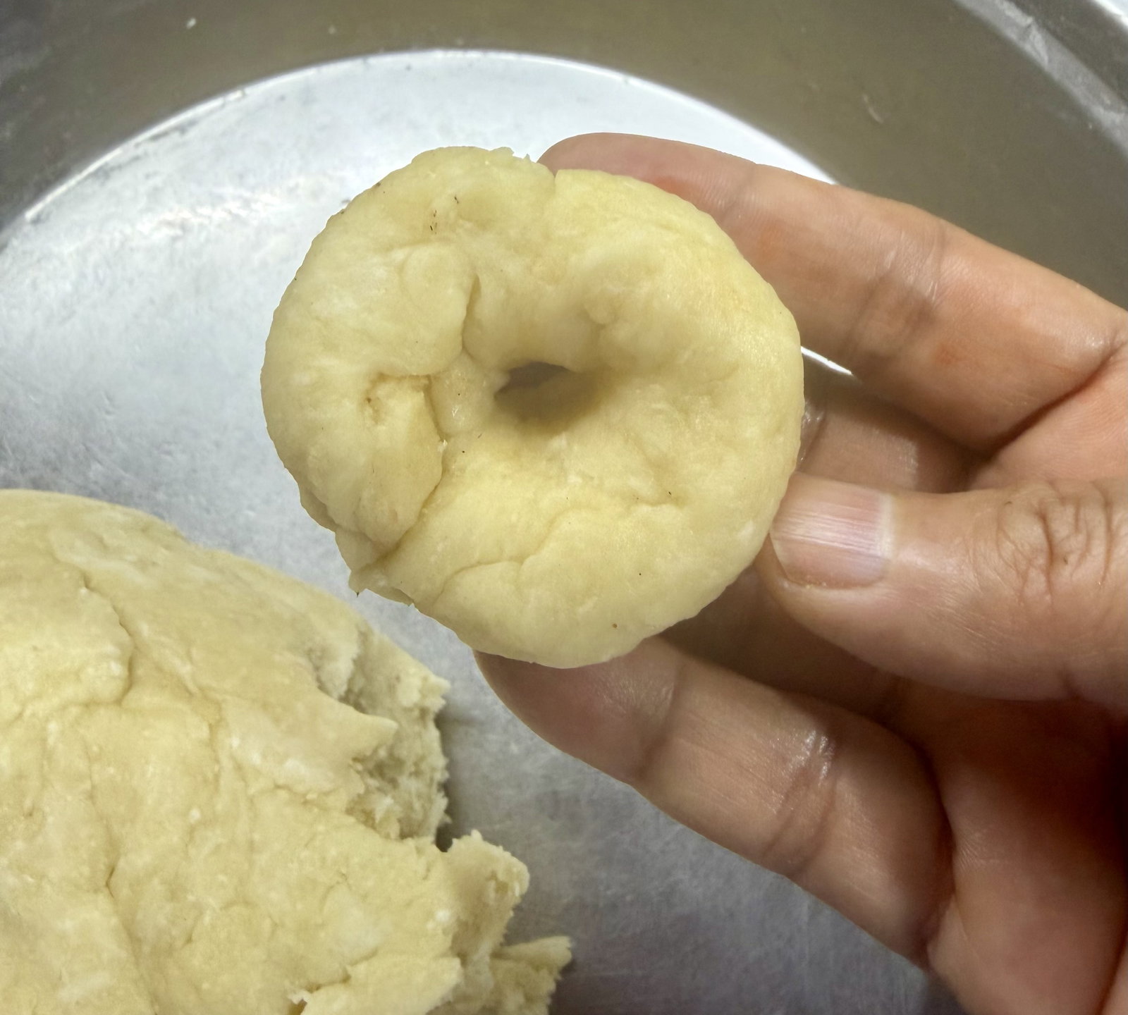 Step 2.1: Flatten each ball slightly with your palm and make a hole in the centre