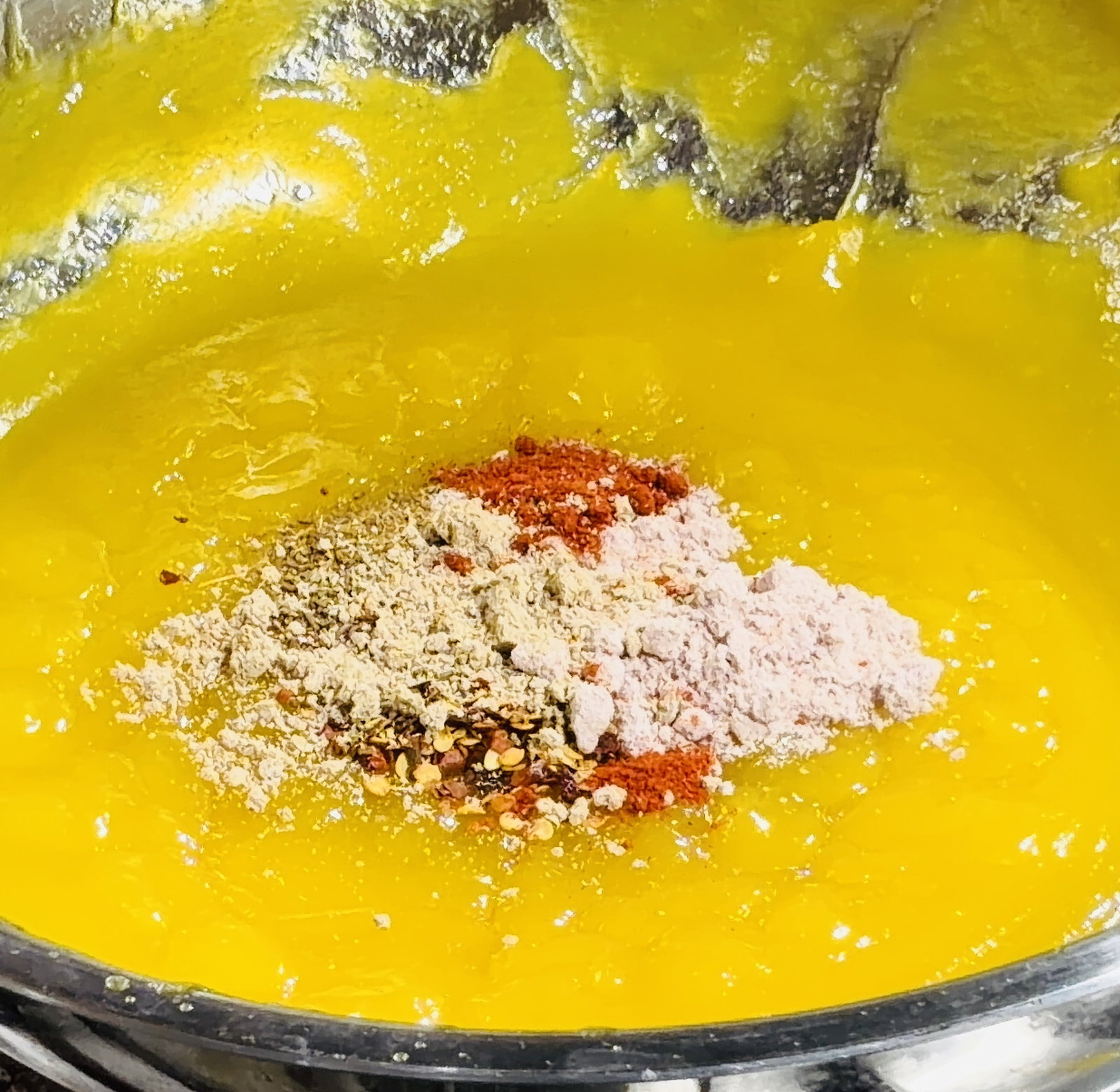 Step 3.1: Quickly add the black salt, Kashmiri red chilli powder, chilli flakes (if using), chaat masala, and roasted cumin powder