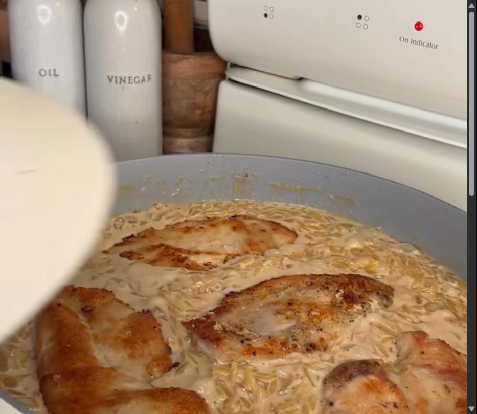 Step 4.1: Add chicken back to pan, lower heat, cover, and simmer for 10 minutes until orzo is cooked through