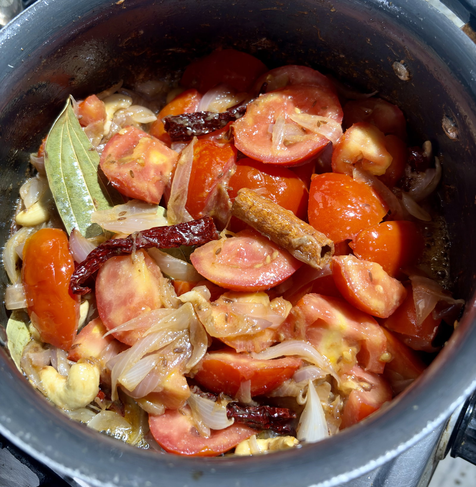 Step 1.1: Add the tomatoes and whole spices (bay leaves, cinnamon, cardamom)