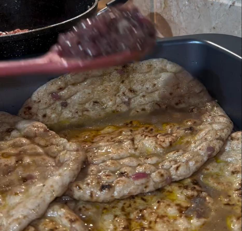 Step 1.1: Dip tanoor bread (or naan bread) in the oil and onion sauce