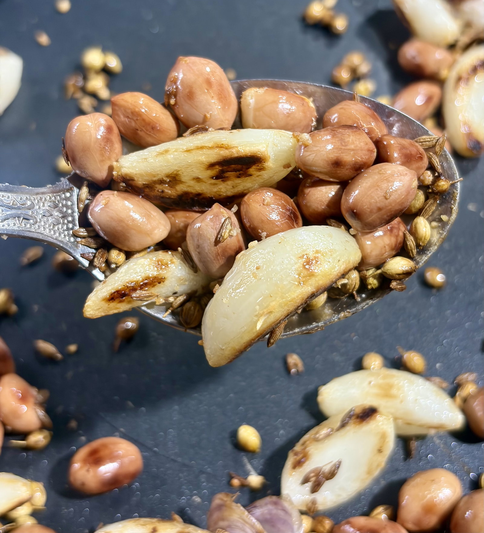 Step 3.1: Lower the heat and add the cumin seeds, coriander seeds, and hing