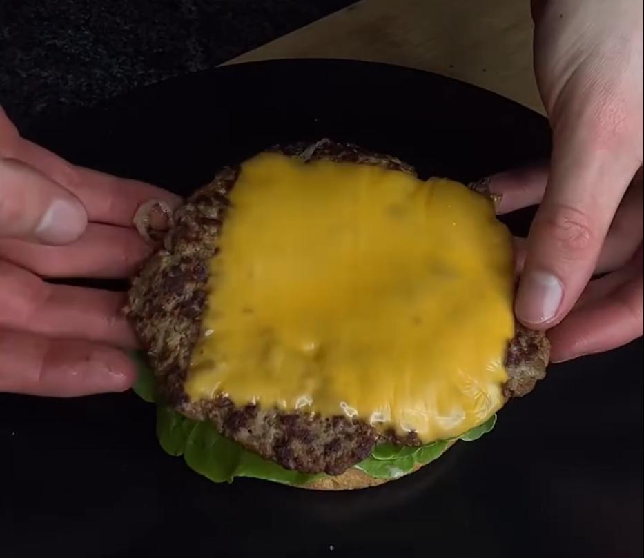 Step 3.1: Flip patties, add a slice of cheese to each, and let it melt