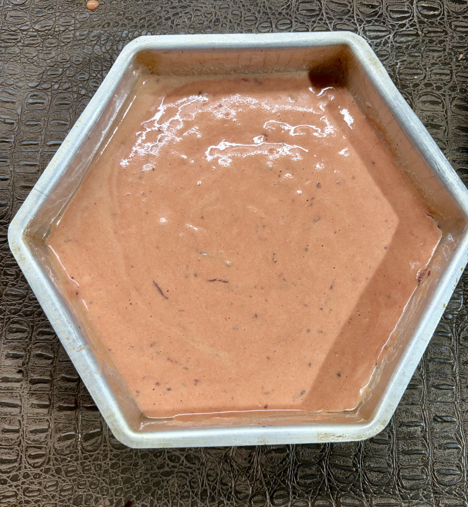 Step 3.1: Pour the batter into the greased mould and tap gently to release large air bubbles