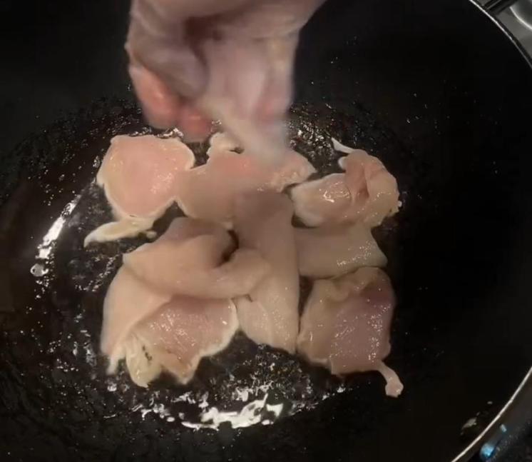 Step 1.1: Heat peanut oil in a pan and cook the chicken, seasoning with black pepper, until golden and cooked through