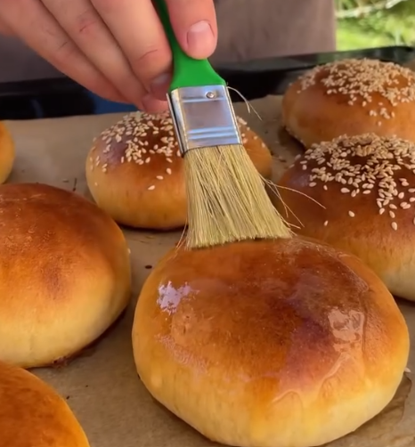 Step 4.1: While still warm, brush the buns with melted butter for a glossy finish
