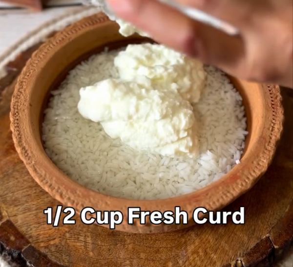 Step 1.1: The next day, add curd and salt to the soaked rice and mix well