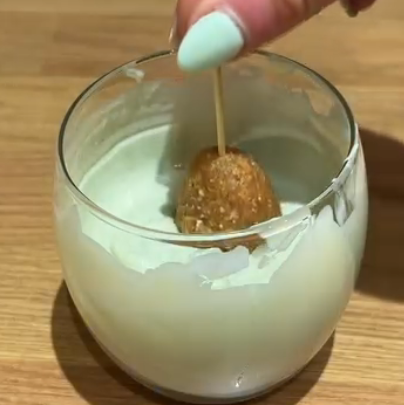 Step 2.1: Insert a cocktail stick into the top of each egg and dip into the chocolate to coat