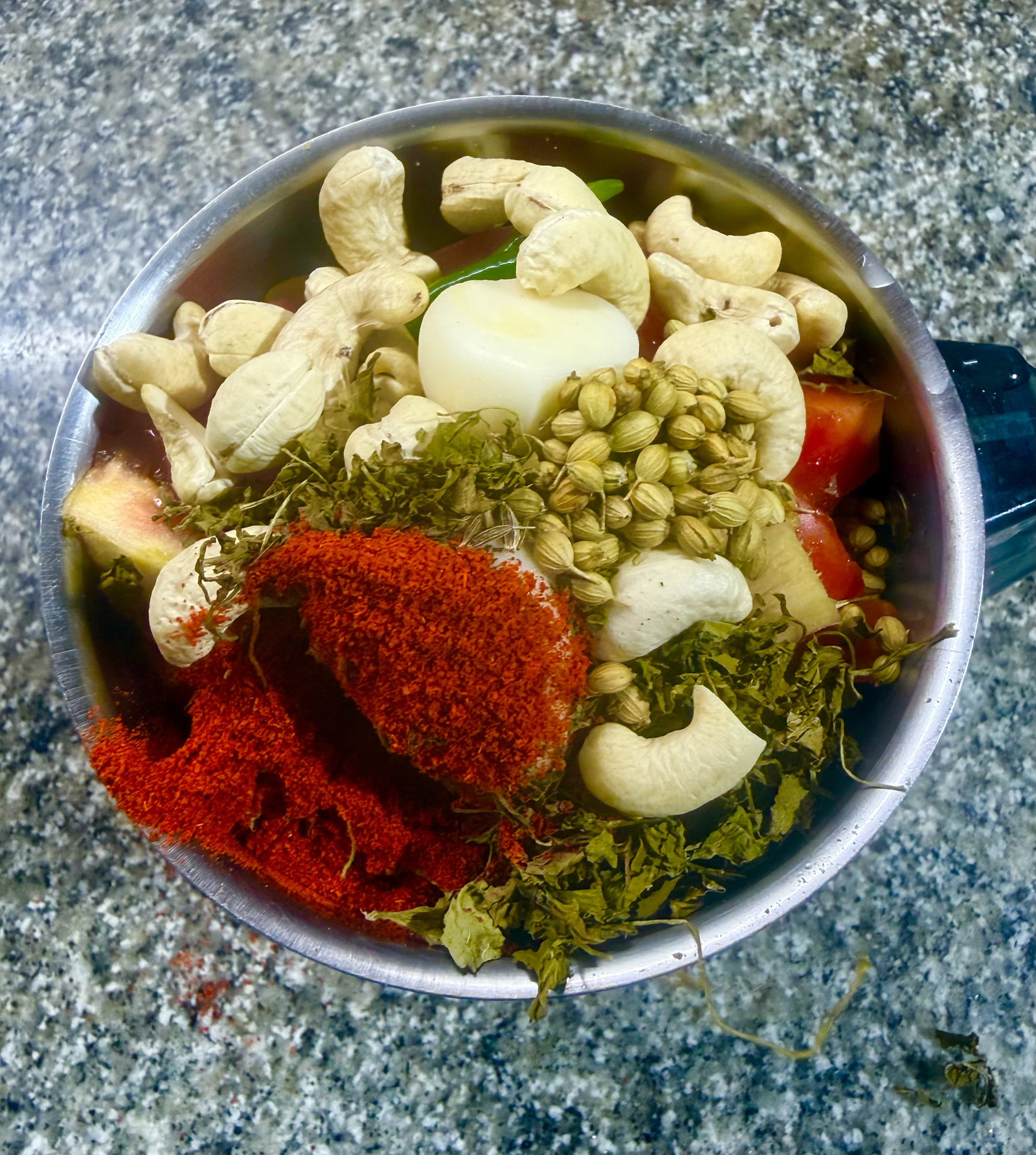 Step 2.1: Add the tomatoes, cashews, green chillies, garlic, ginger, cumin seeds, coriander powder, Kashmiri chilli powder, and kasuri methi to a high-speed blender