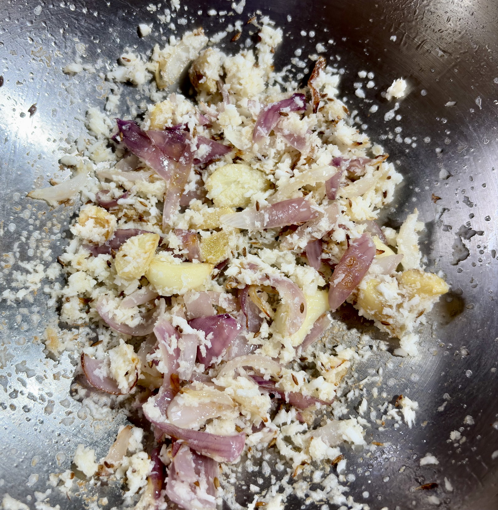 Step 2.1: Stir in the grated coconut and sauté until it turns a light golden-brown