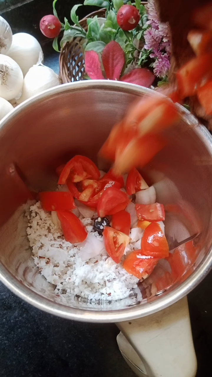 Step 1.1: Add onion diced, tomato diced, coriander seeds, garlic pods, grated coconut, soaked dry red chilli, turmeric powder, and water into a mixie jar